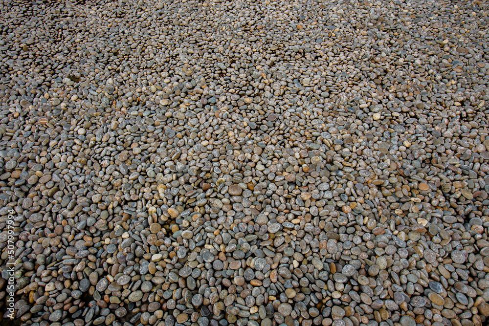 Colorful small round stones in a large stone courtyard Colorful small round stones in a large stone courtyard