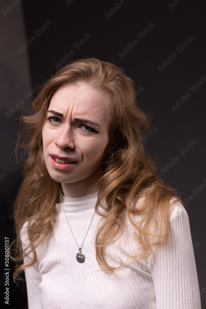 Portrait of thoughtful, dissatisfied, pensive young woman. Blong girl face isolated. Emotional woman immersed in your thoughts, suspicious and
incredulous