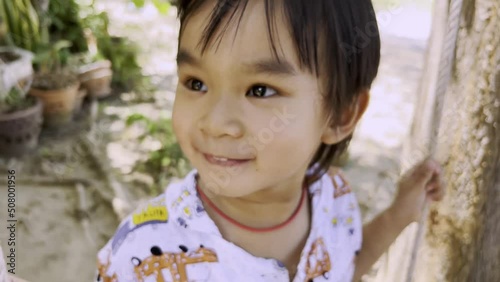Funny kid boy having fun with rope swing on outdoor playground