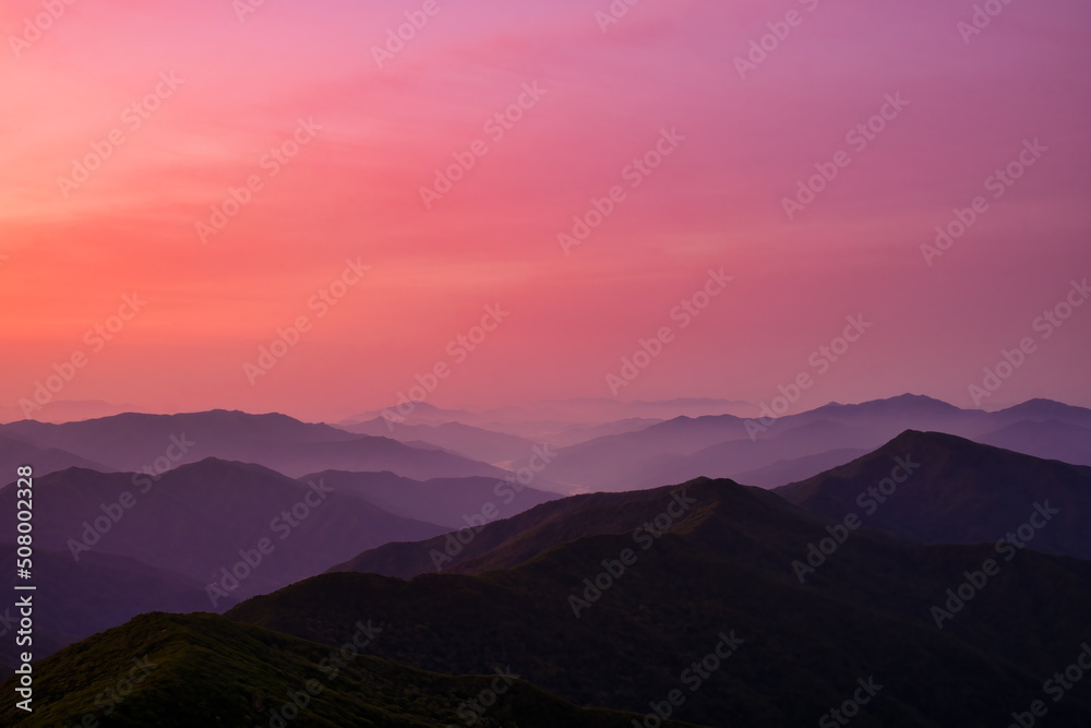 Scenic view of the mountains during sunrise Scenic view of the mountains during sunrise