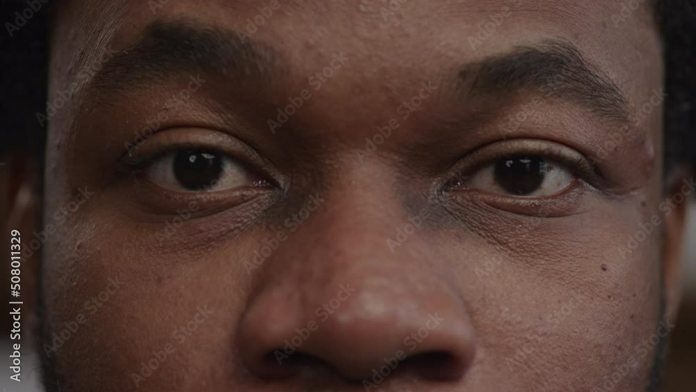 Extreme close-up of a surprised african-american man's eyes open an raise the eyebows Extreme close-up of a surprised african-american man's eyes open an raise the eyebows