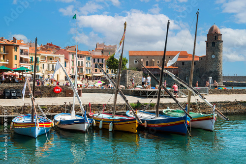 view on colorful sailing boats front of the famous tower of the france french city of collioure photo