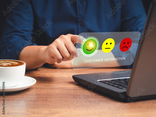 Positive feedback concept. Choosing a green happy mood icon rating review in the survey, poll, or customer satisfaction research on a virtual screen