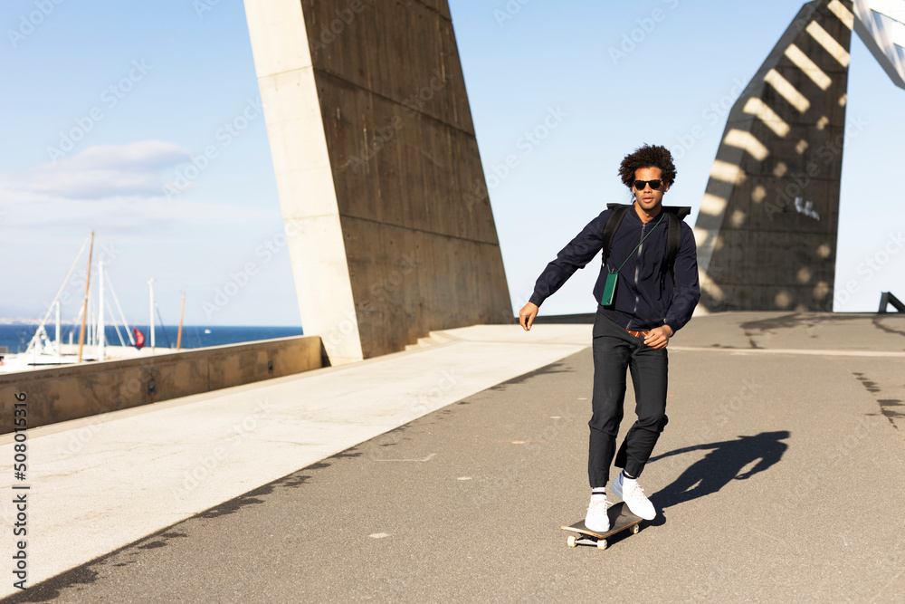 Handsome man with skateboard. Young smiling man having fun outdoors..
