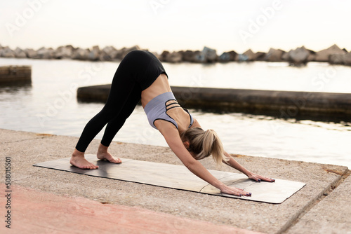 Young woman doing stretching exercise after running outside. Healthy lifestyle.