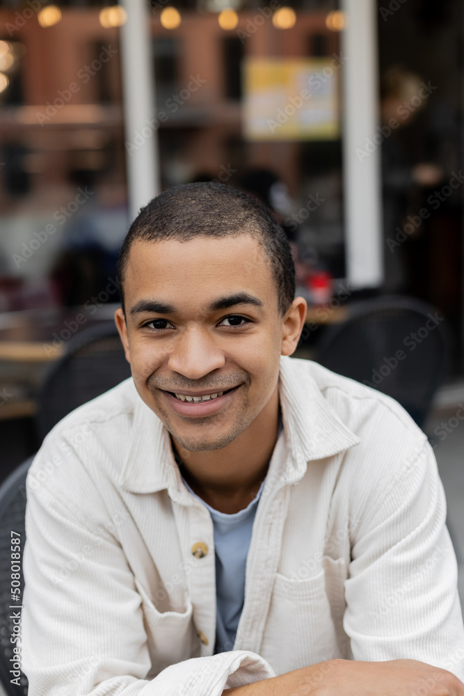 portrait of happy african american man sitting on summer terrace. portrait of happy african american man sitting on summer terrace.