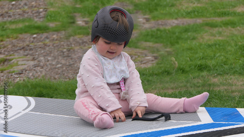 Baby girl wearing a cranial remoulding helmet flat head