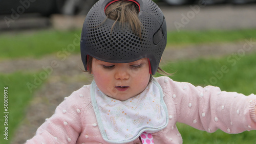 Baby girl wearing a cranial remoulding helmet flat head