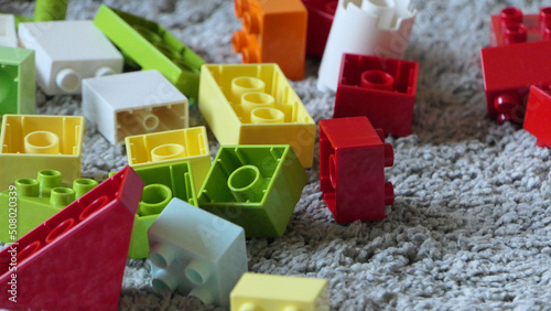 Mix of Colourful Pieces of Bricks sitting on mat indoors
