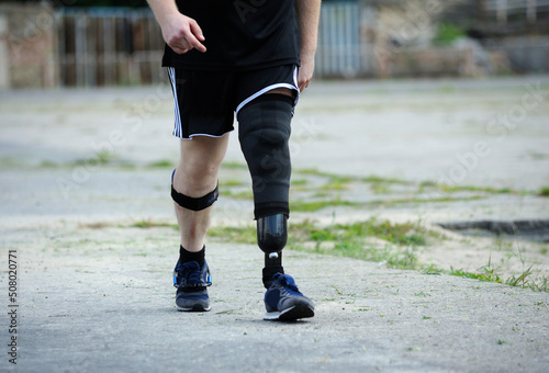 one-legged runner walking on a stadium