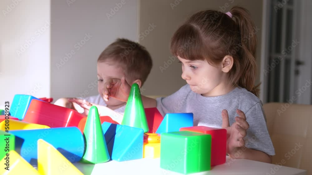 kids girl and baby indoor boy play in kindergarten. a group of children play toys cubes and cars on the table in kindergarten. happy family preschool education concept. nursery baby toddler home kids girl and baby indoor boy play in kindergarten. a group of children play toys cubes and cars on the table in kindergarten. happy family preschool education concept. nursery baby toddler home