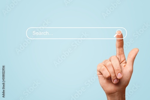 Searching information concept. Hand of man touching in icon search photo