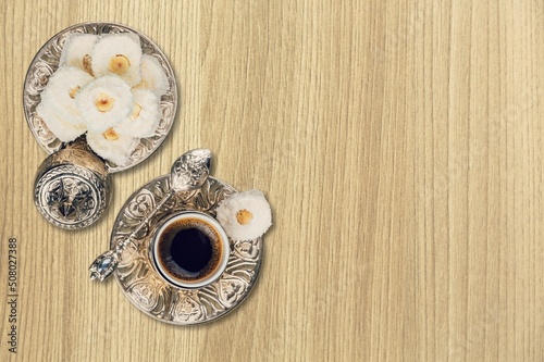Ramadan food, Turkish coffee and dates zinc tray on desk.