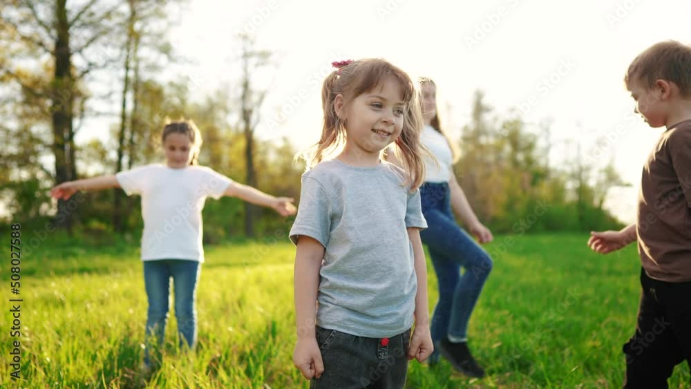 group of children in the park portrait. happy family baby kid dream concept. kindergarten. children play on green grass in forest sun park in summer sunlight group of children in the park portrait. happy family baby kid dream concept. kindergarten. children play on green grass in forest sun park in summer sunlight