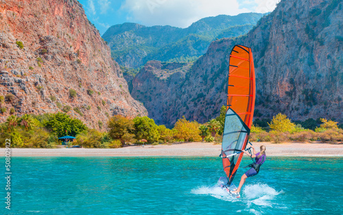 Beautiful cloudy sky with Windsurfer Surfing The Wind On Waves Butterfly beach Valley - Oludeniz, Fethiye