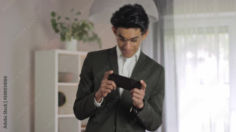 Well Dressed Student Playing Mobile Games Before Exam, Standing Medium Shot Well Dressed Student Playing Mobile Games Before Exam, Standing Medium Shot