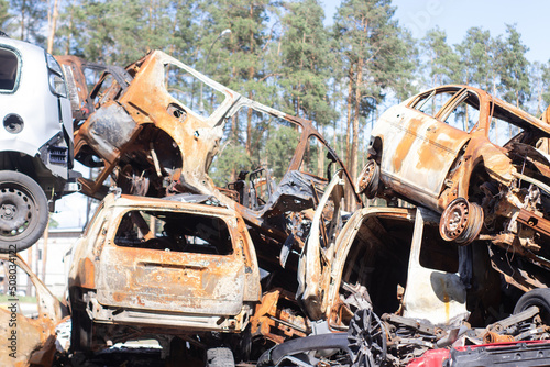 car graveyard. Burnt and blown up car. Cars damaged after shelling from russian invasion. War between Russia and Ukraine. Terror attack bomb shell. Disaster area irpin bucha