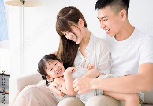 Happy Asian family having fun at home.