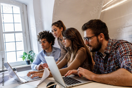 Fotografie Group of casually dressed young coworkers on meeting ,discussing new business ideas
