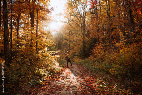 Couple embracing each other in autumn forest in Canada