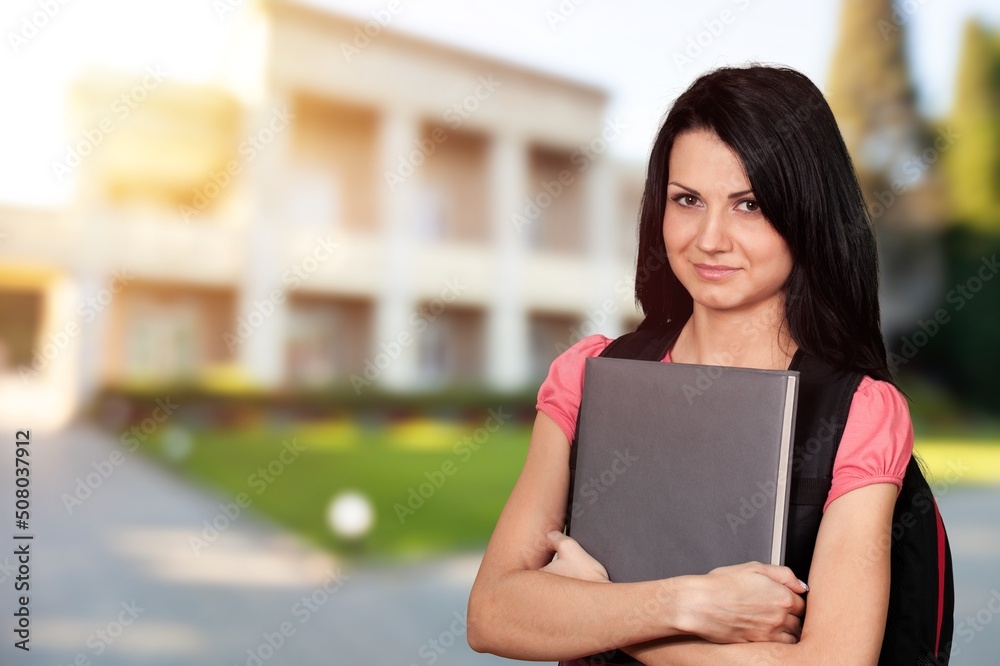 Obraz premium A brainstorming clever student hold netbook posing