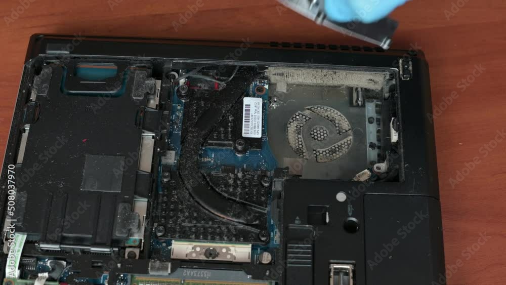 cleaning laptop close up. cleaning the laptop cooling system from dust. the master dismantles the details of the laptop. cleaning laptop close up. cleaning the laptop cooling system from dust. the master dismantles the details of the laptop.