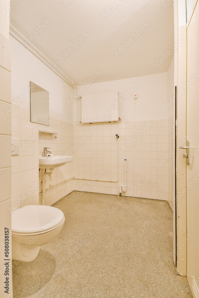 Old sink with mirror near toilet in light bathroom Old sink with mirror near toilet in light bathroom