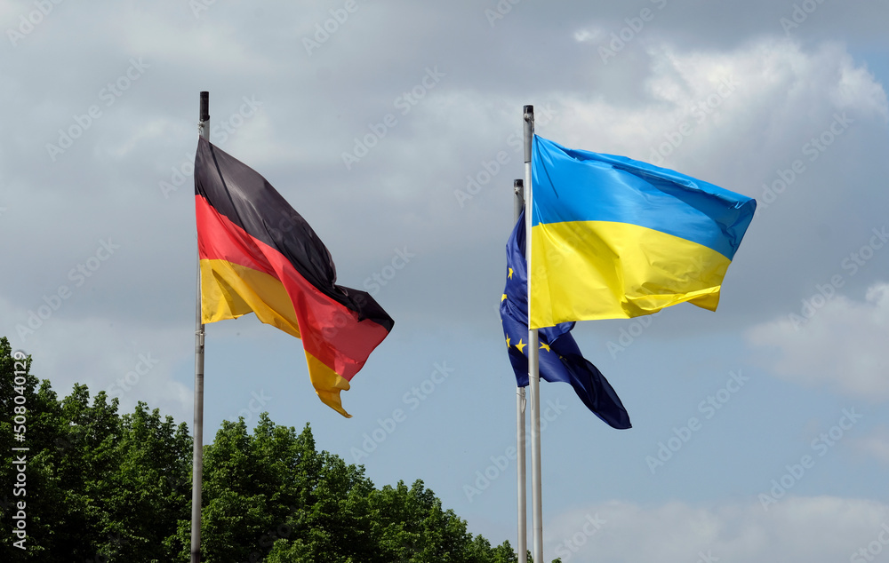 The flags of Ukraine, Germany, and the EU waving in the wind The flags of Ukraine, Germany, and the EU waving in the wind