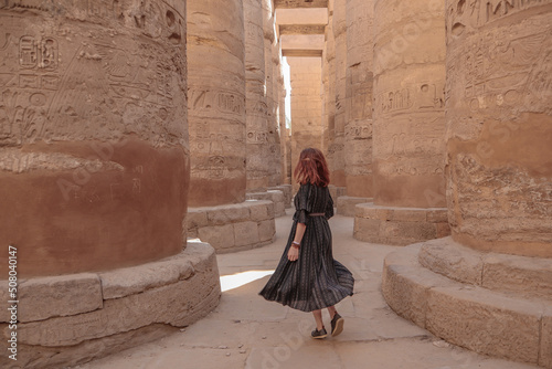 Woman between the pillars in the temple of Karnak in Luxor. photo