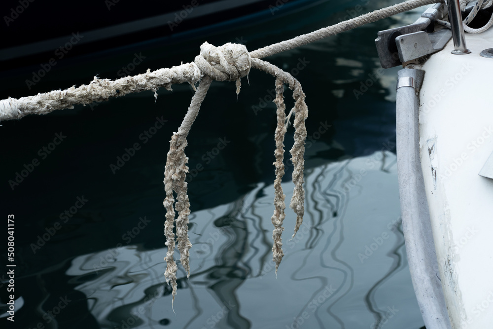 Fototapeta premium Old worn mooring rope of a yacht marine background.