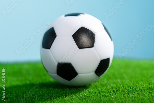 Classic football ball on a green grass. © dimasobko