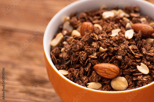 Chocolate granola with almond, nuts in a bowl