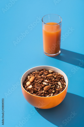 Granola with almond and peanut in orange bowl