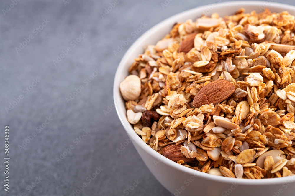Fresh granola with almonds in a white bowl. Fresh granola with almonds in a white bowl.
