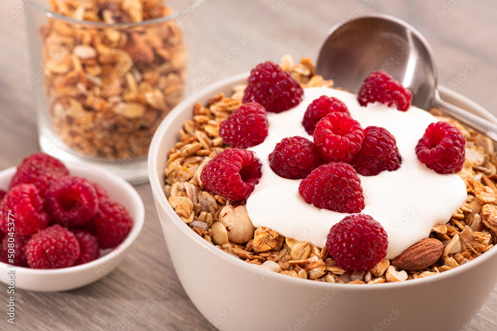 Sweet breakfast with granola, yogurt and fresh raspberries Sweet breakfast with granola, yogurt and fresh raspberries