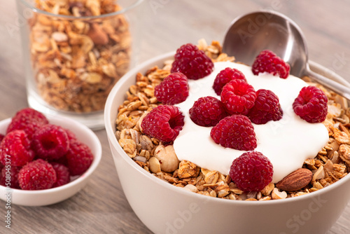 Sweet breakfast with granola, yogurt and fresh raspberries