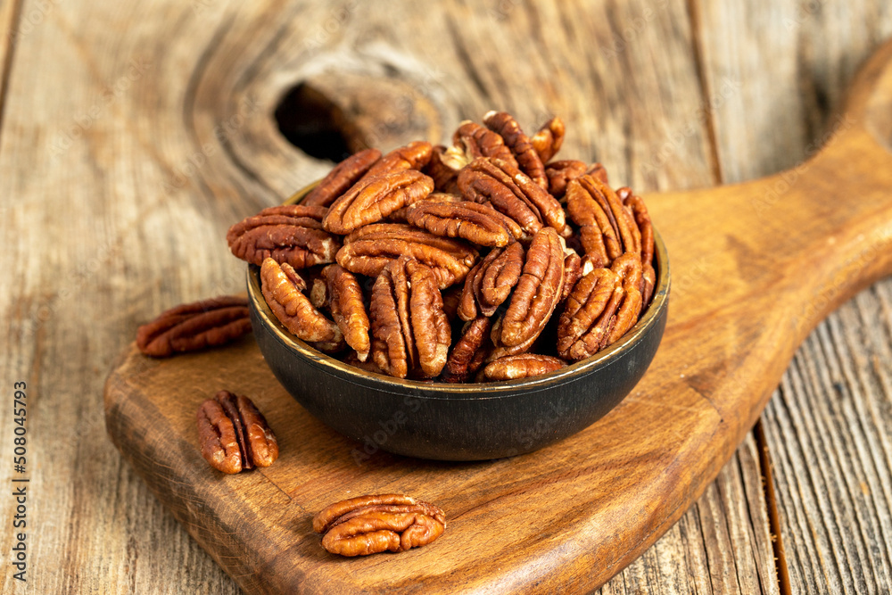 Pecan walnuts on wooden background. close up Pecan walnuts on wooden background. close up