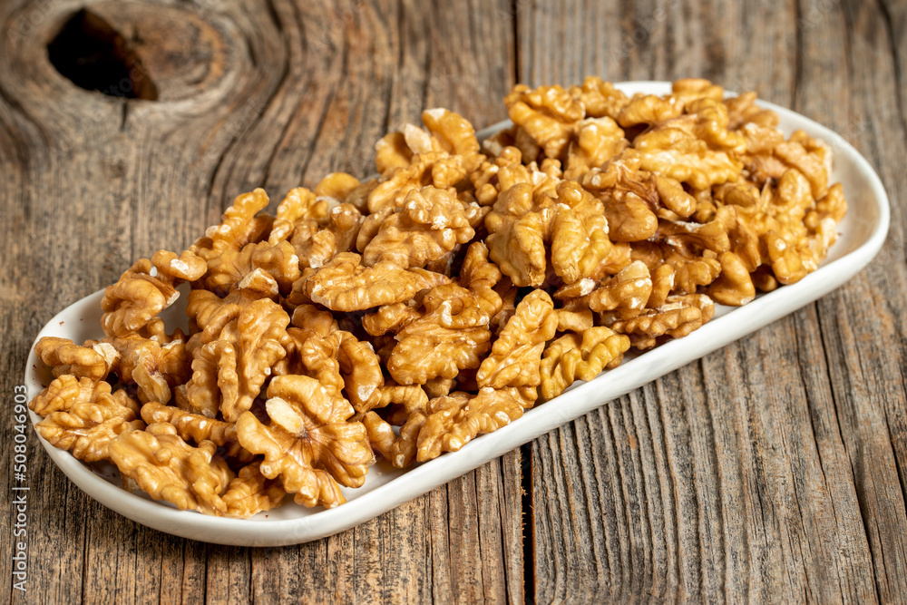 Walnut on wooden background. Close-up walnut kernel Walnut on wooden background. Close-up walnut kernel