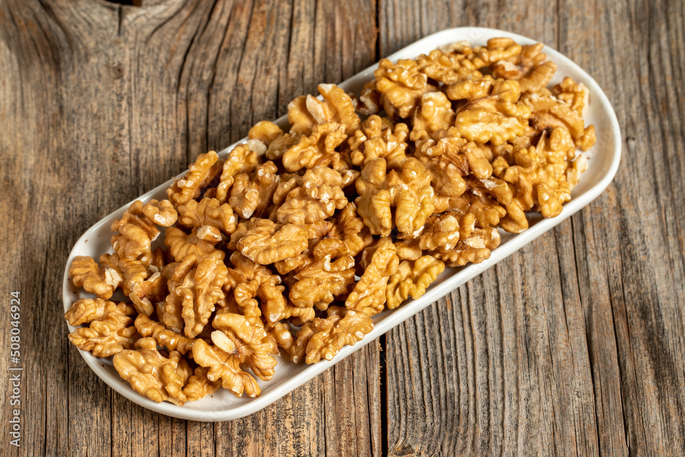 Walnut on wooden background. Close-up walnut kernel Walnut on wooden background. Close-up walnut kernel