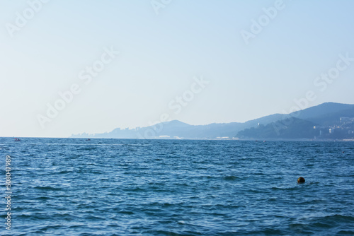 Minimalistic seascape, sea and mountains lost in a blue haze © Liiiz