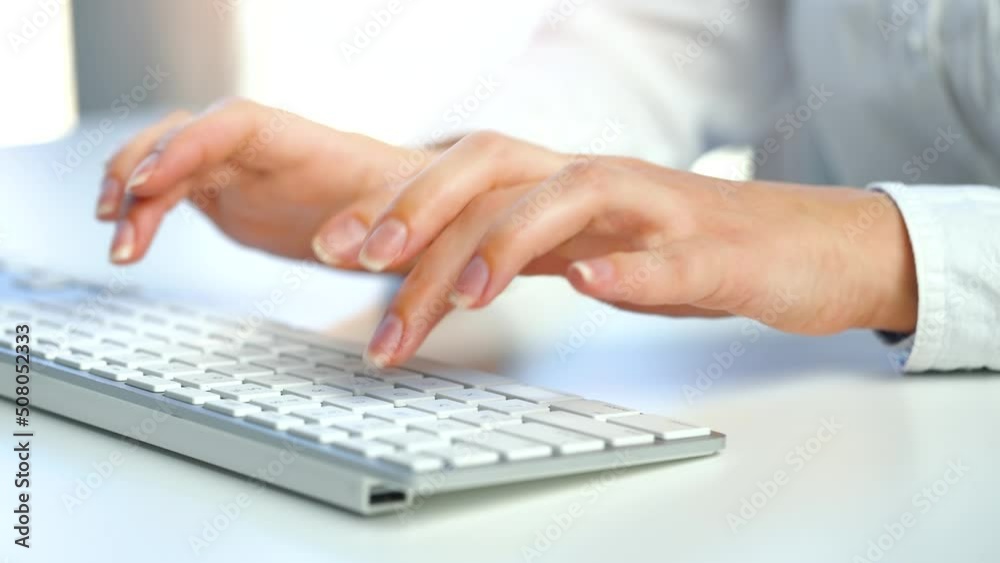 Female hands busy working on computer keyboard for sending emails and surf on a web browser Female hands busy working on computer keyboard for sending emails and surf on a web browser
