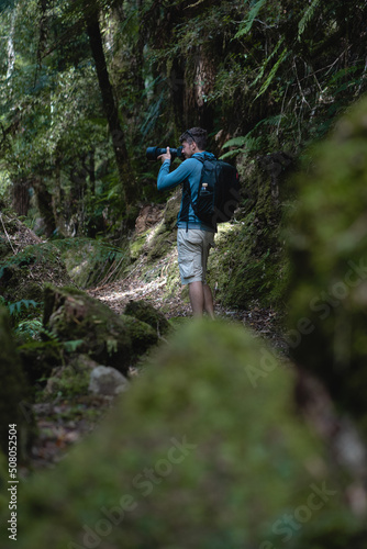 Photographer working by the side of a trail in the forest © Pajaros Volando