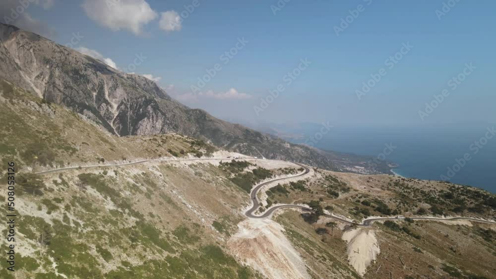 Flying out of clouds toward Llogara mountain pass in Albania. Aerial view of winding road Flying out of clouds toward Llogara mountain pass in Albania. Aerial view of winding road