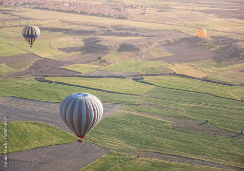 hot air balloon above green agricultural field in Cappadocia