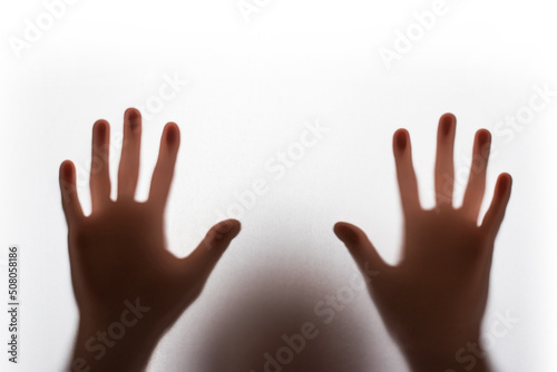 Abstract blur hands silhouettes behind glass foreground
