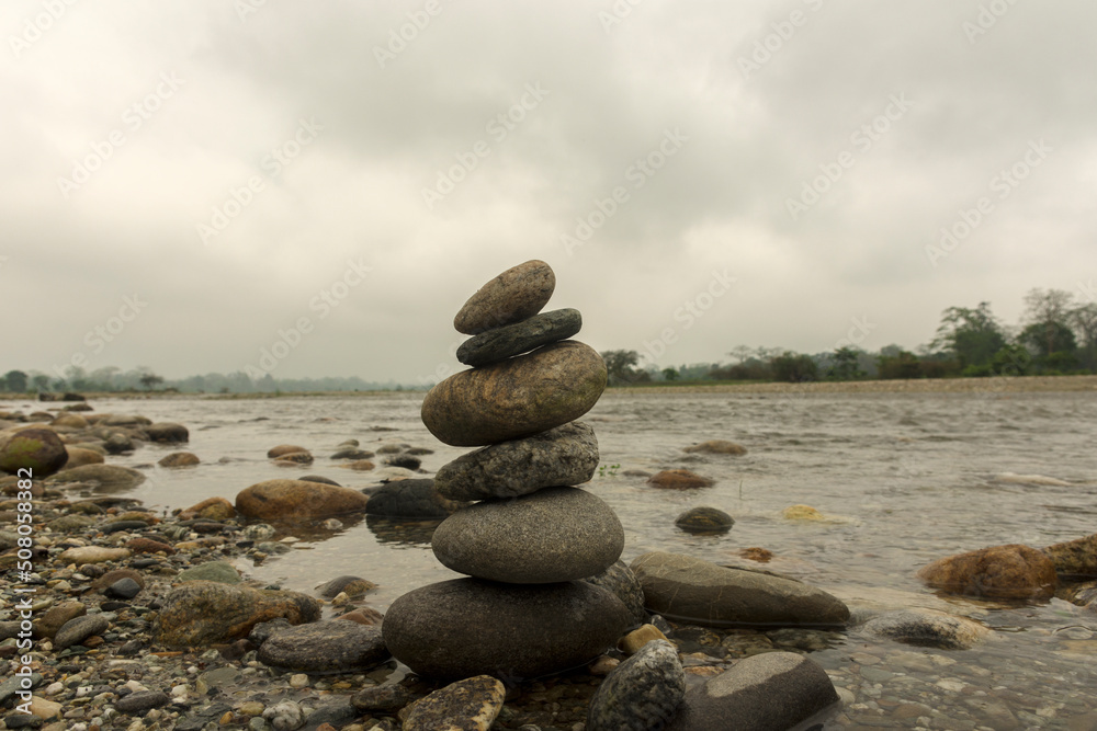 Pile of stones placed from smallest to largest one on top of the other beside Murti river a popular tourist destination in Dooars area West Bengal, India. Pile of stones placed from smallest to largest one on top of the other beside Murti river a popular tourist destination in Dooars area West Bengal, India.