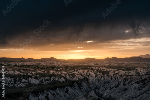dramatic sunset and rainclouds over the desert of Cappadocia