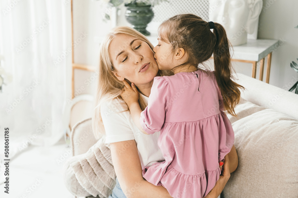 A little girl hugs her mother. Granddaughter hugs her grandmother. A little girl hugs her mother. Granddaughter hugs her grandmother.