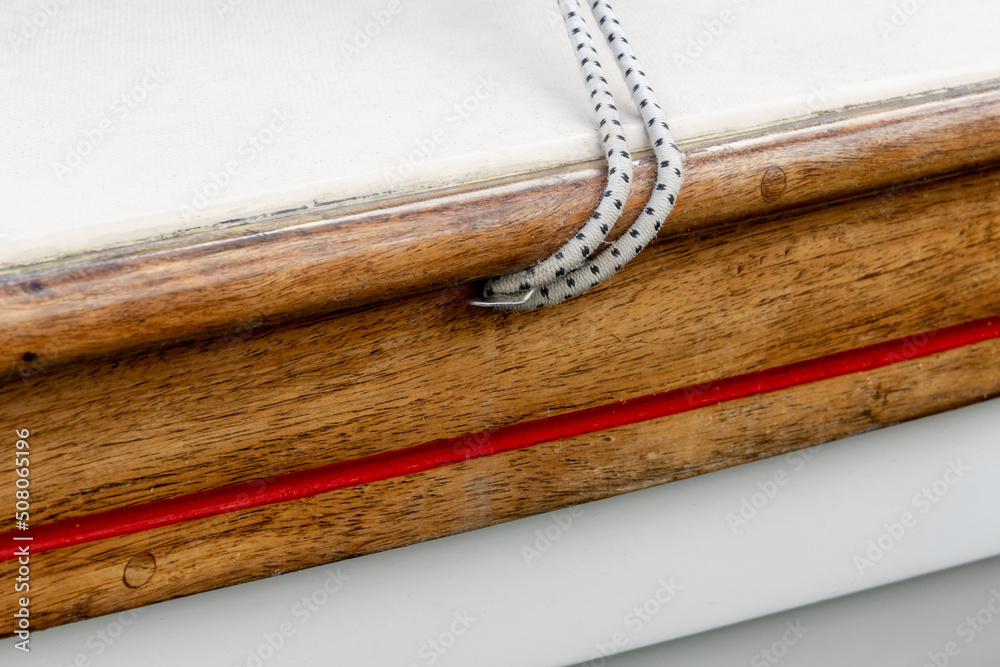 Diagonal Lines Of Shock Cord Rope Coming Out of Varnished Gunnel on a