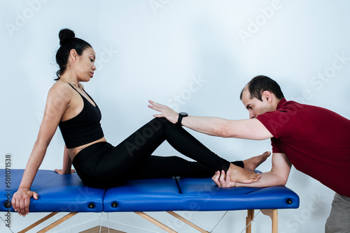 Therapist mobilizing the ankles of a young woman